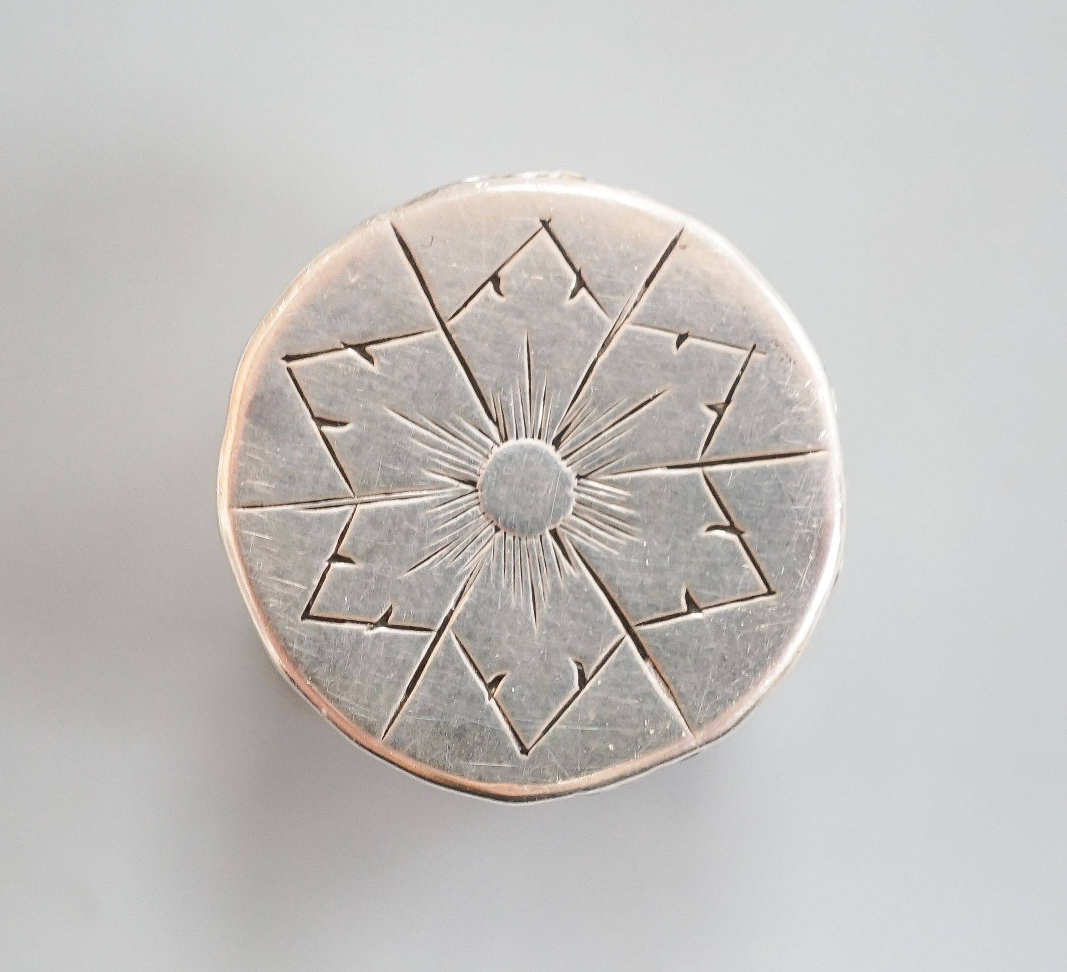 A mid 18th century German? small pill box, with engraved flower head decoration, 19mm.